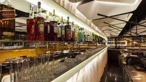 A bar area with various liquor bottles and glasses. - Quentin Boutique Hotel (Berlin)