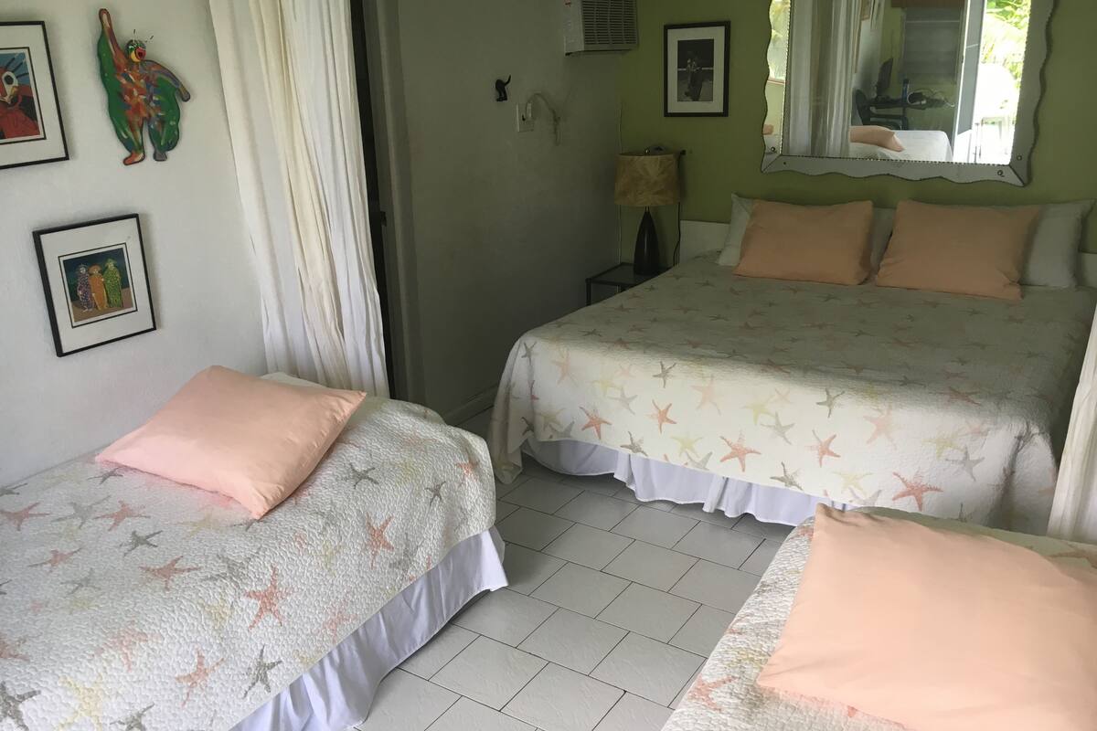 Ein Hotelzimmer mit zwei Betten, jeweils mit einem sternenmusterüberzogenen Bett und passenden Kissen.