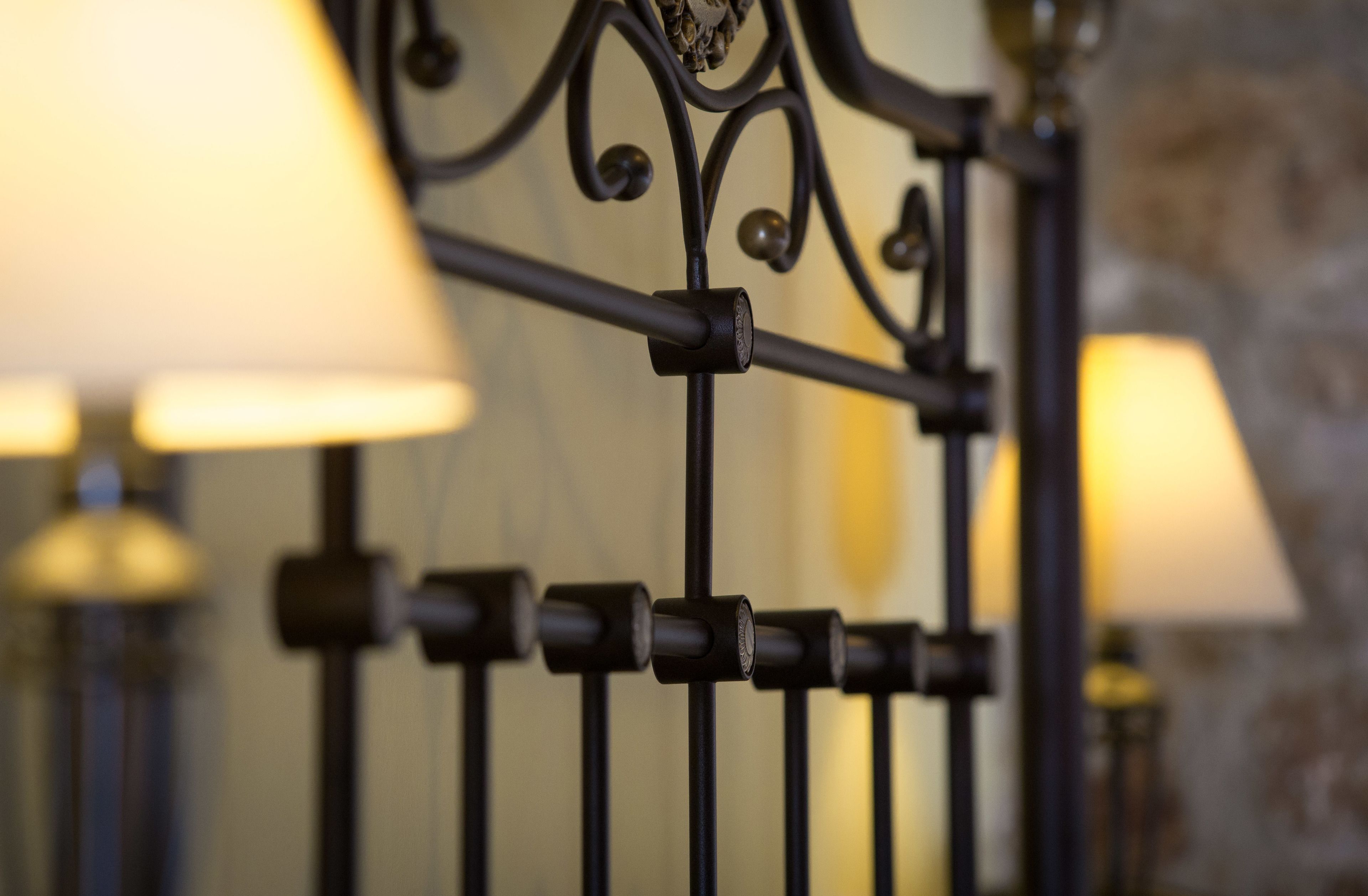 A close-up of a metal railing with a series of cylindrical objects attached to it.