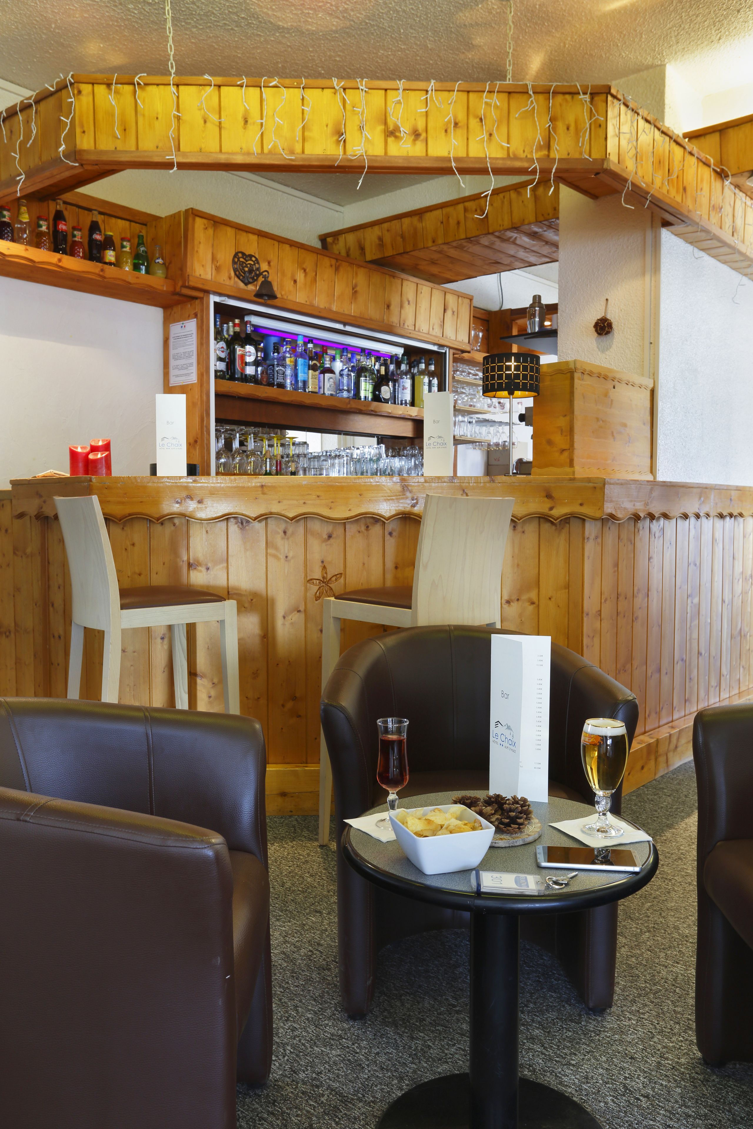 A restaurant with wooden decor, a bar area, and seating for guests.