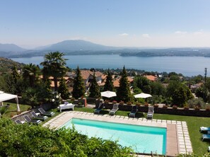 Outdoor pool, open 9:00 AM to 8:00 PM, pool umbrellas, pool loungers