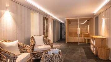 Relax in a serene spa area with a seating area, teapot, and towels.