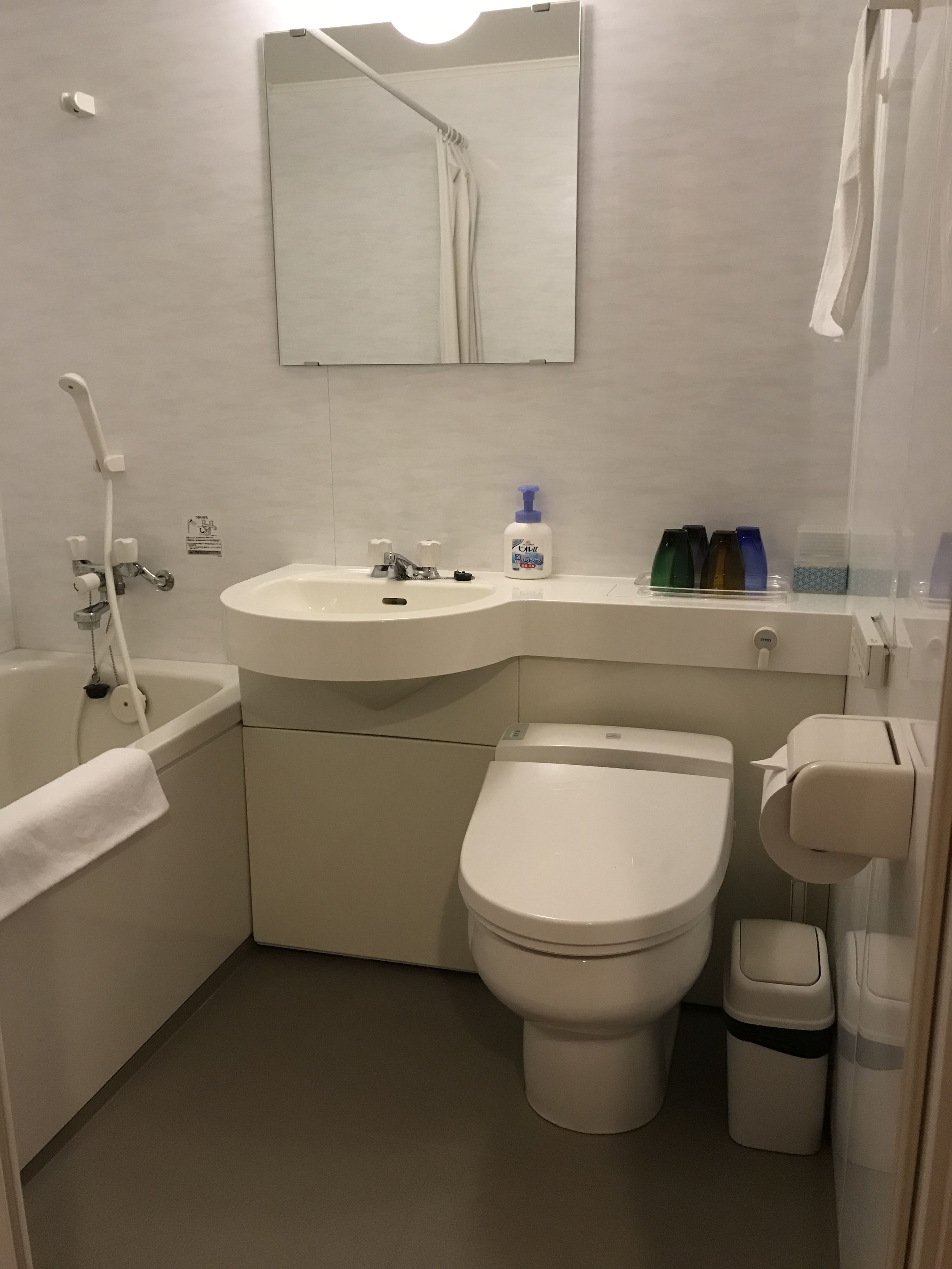 A modern bathroom with a bathtub, a sink, a toilet, and a shower.