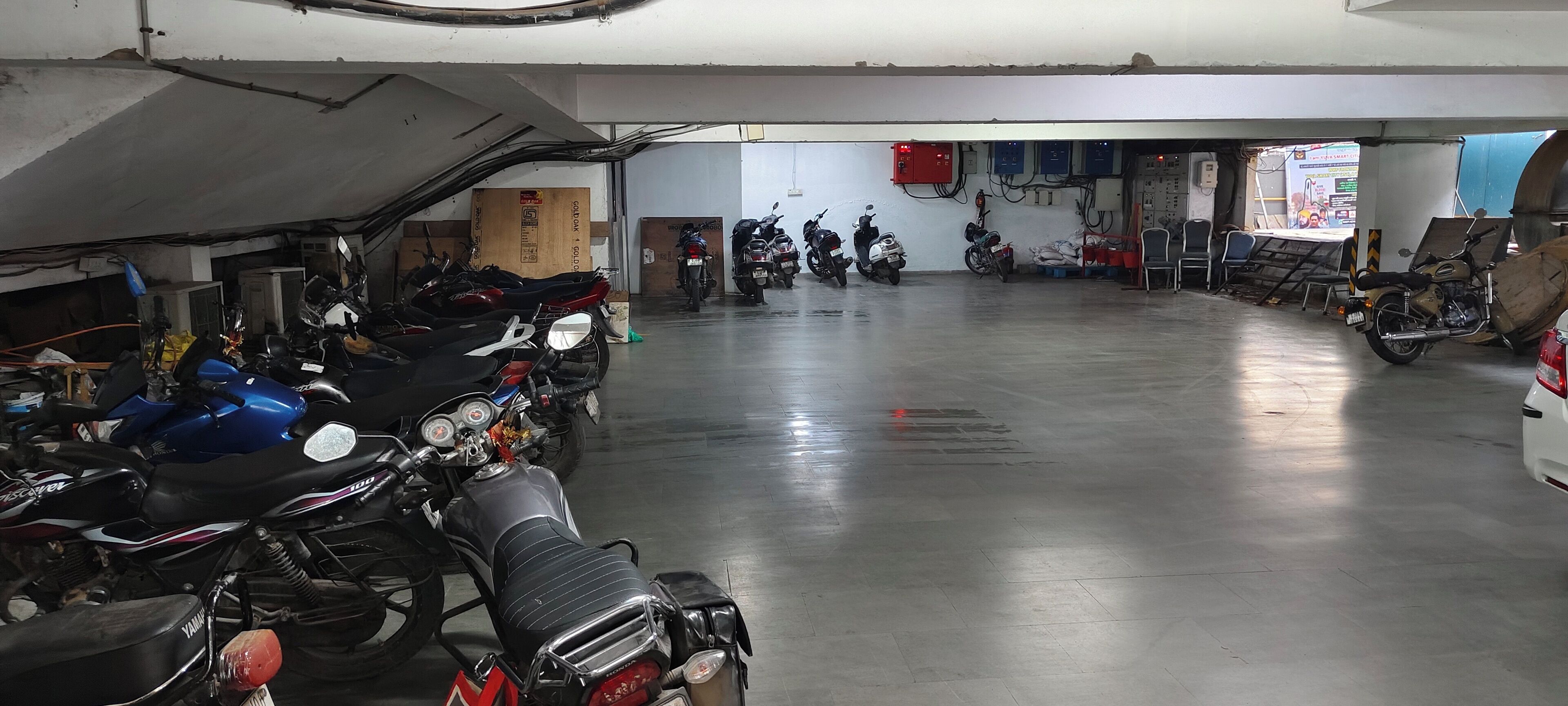 A motorcycle repair shop with several motorcycles parked in rows.