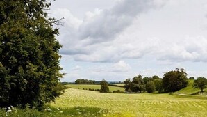 A rural landscape with rolling hills, fields, and scattered trees. - The Blacksmiths Arms (Lewes)