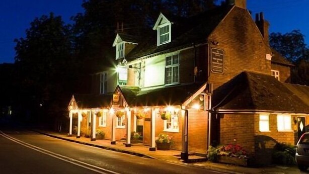 A traditional pub with a brick facade, multiple windows, and a signboard. - The Blacksmiths Arms (Lewes)