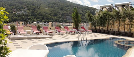 Outdoor pool, open 11:00 AM to 8:00 PM, pool loungers