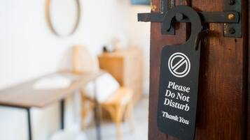 A door with a sign that reads 'Please Do Not Disturb Thank You.'