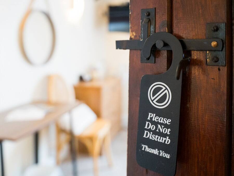 A door with a sign that reads 'Please Do Not Disturb Thank You.'