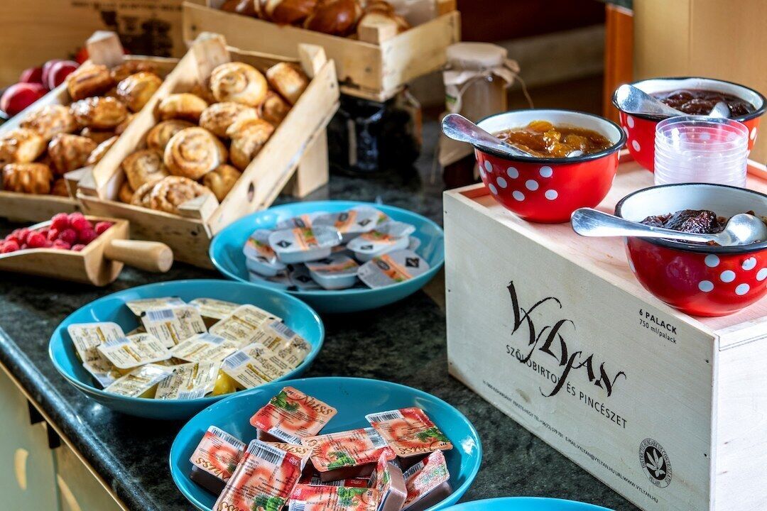 A buffet table with various food items and containers.