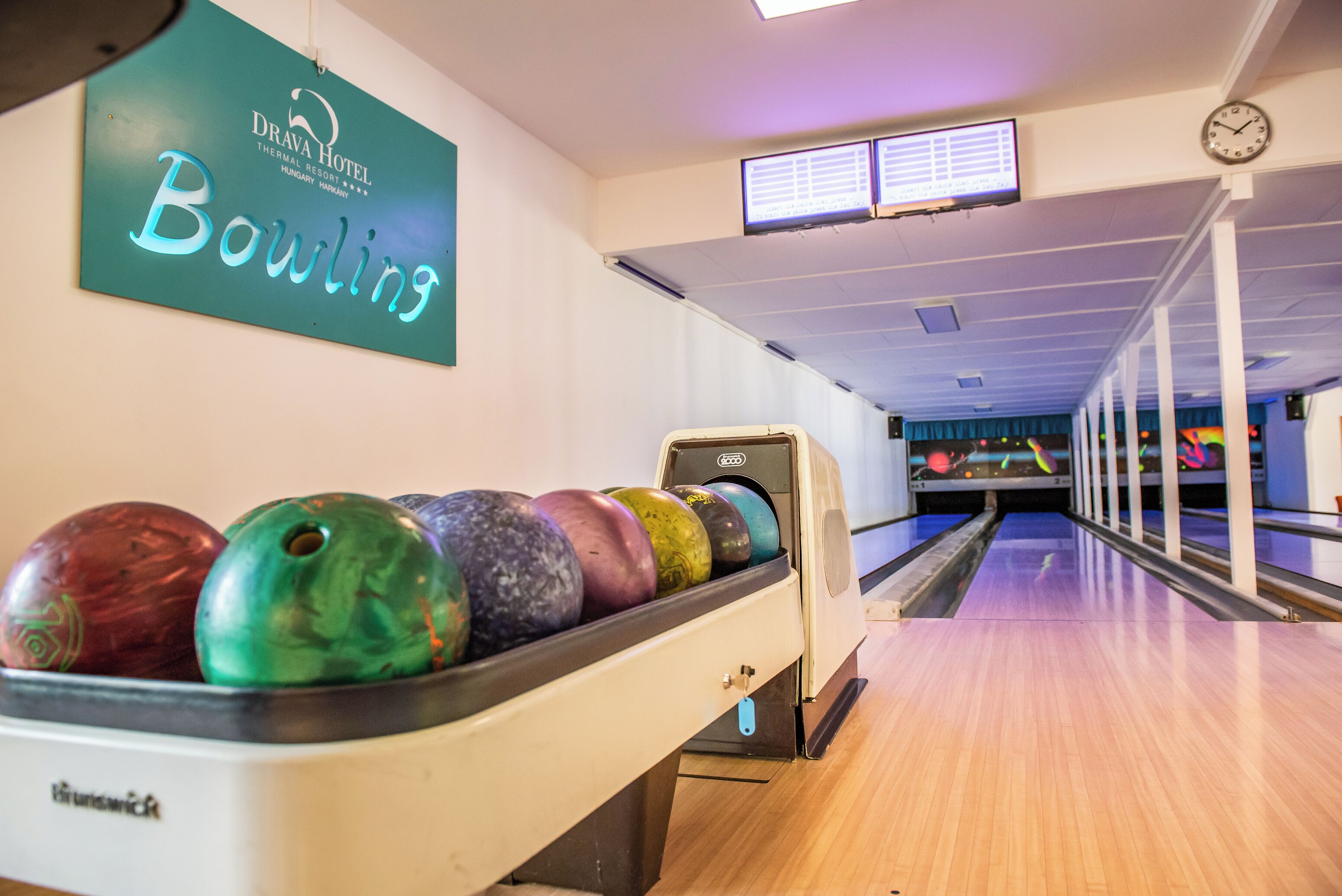 A bowling alley with a sign for Drava Hotel Thermal Resort.