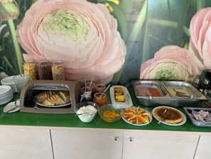 A buffet table with various food items and condiments. - Anatoli Beach (Apokoronas)