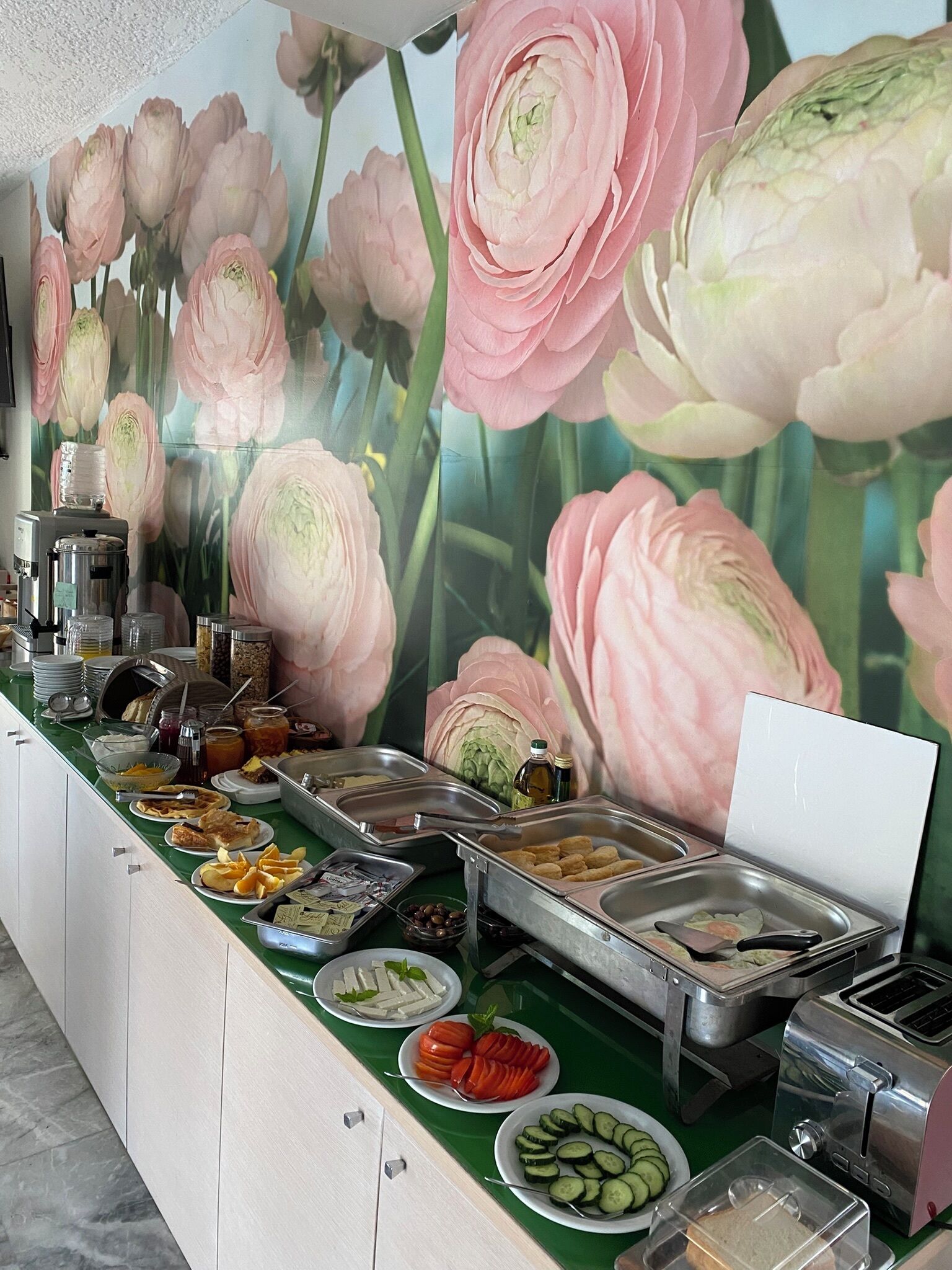 A buffet setup with various food items and a toaster.