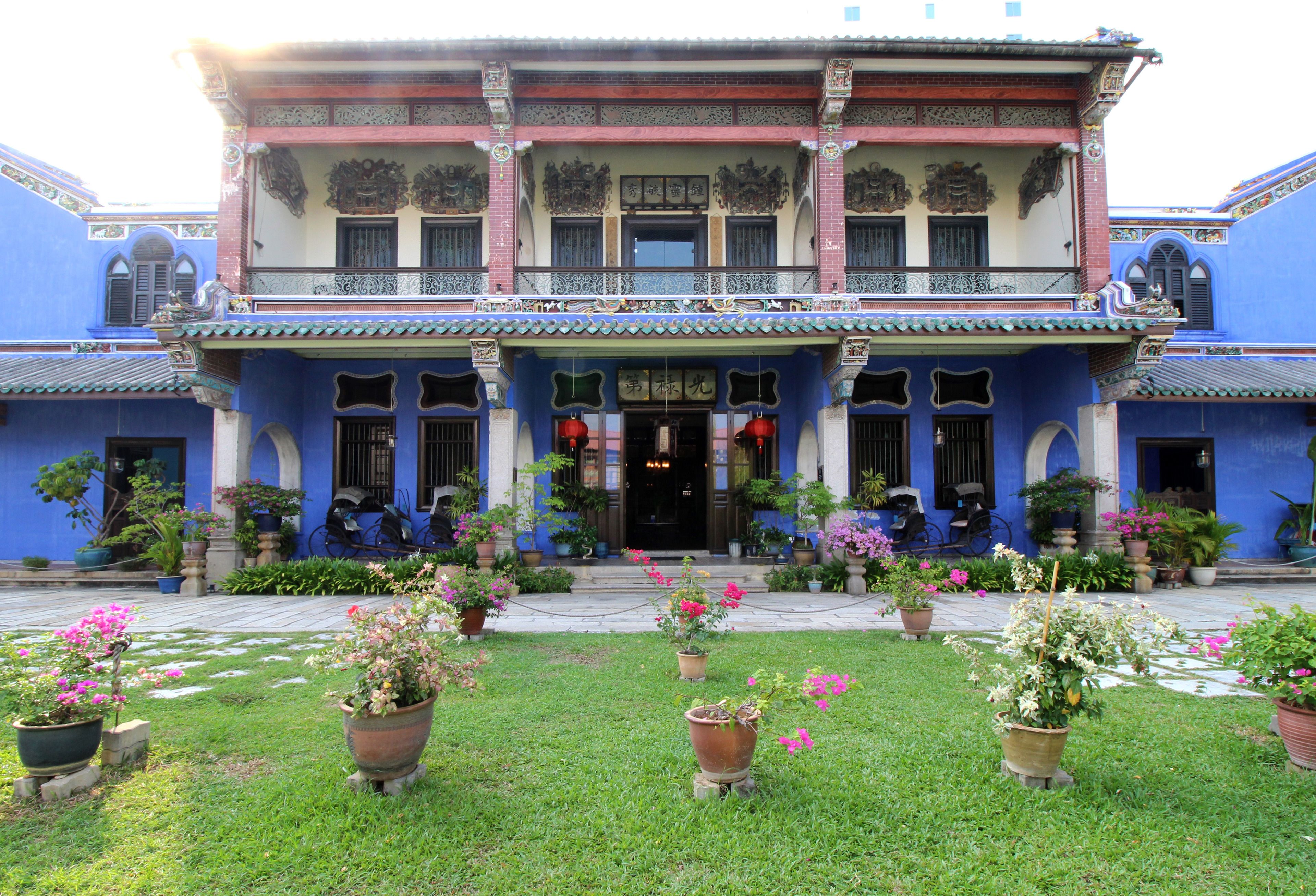 A traditional building with a two-story facade, large windows, and a central entrance.
