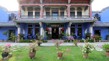 A traditional building with a two-story facade, large windows, and a central entrance.