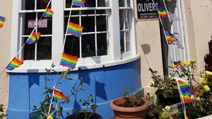 A building with a blue lower section and a white upper section, labeled "WATERLOO PLACE". - Olivers Guest House (Weymouth)