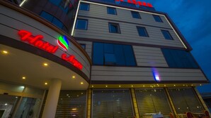 A hotel with a modern facade, large windows, and a prominent sign reading "HOTEL ARAMARK." - Arsen Hotel (Arsin)