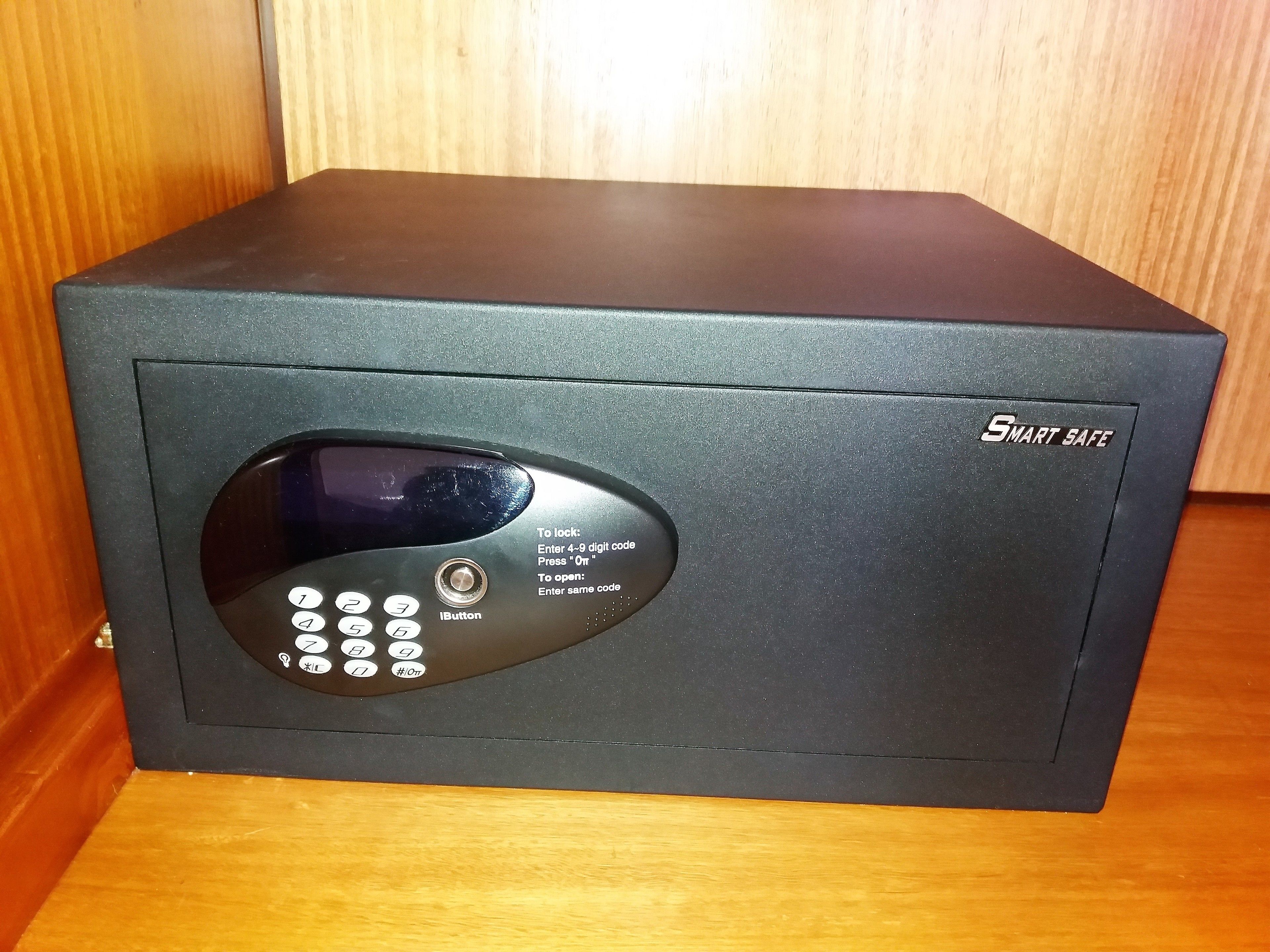 A black safe with a keypad and a digital display, labeled "SMART SAFE."