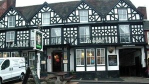 A traditional black and white Tudor-style building with a sign reading "The Hotel." - Talbot Hotel (Kidderminster)