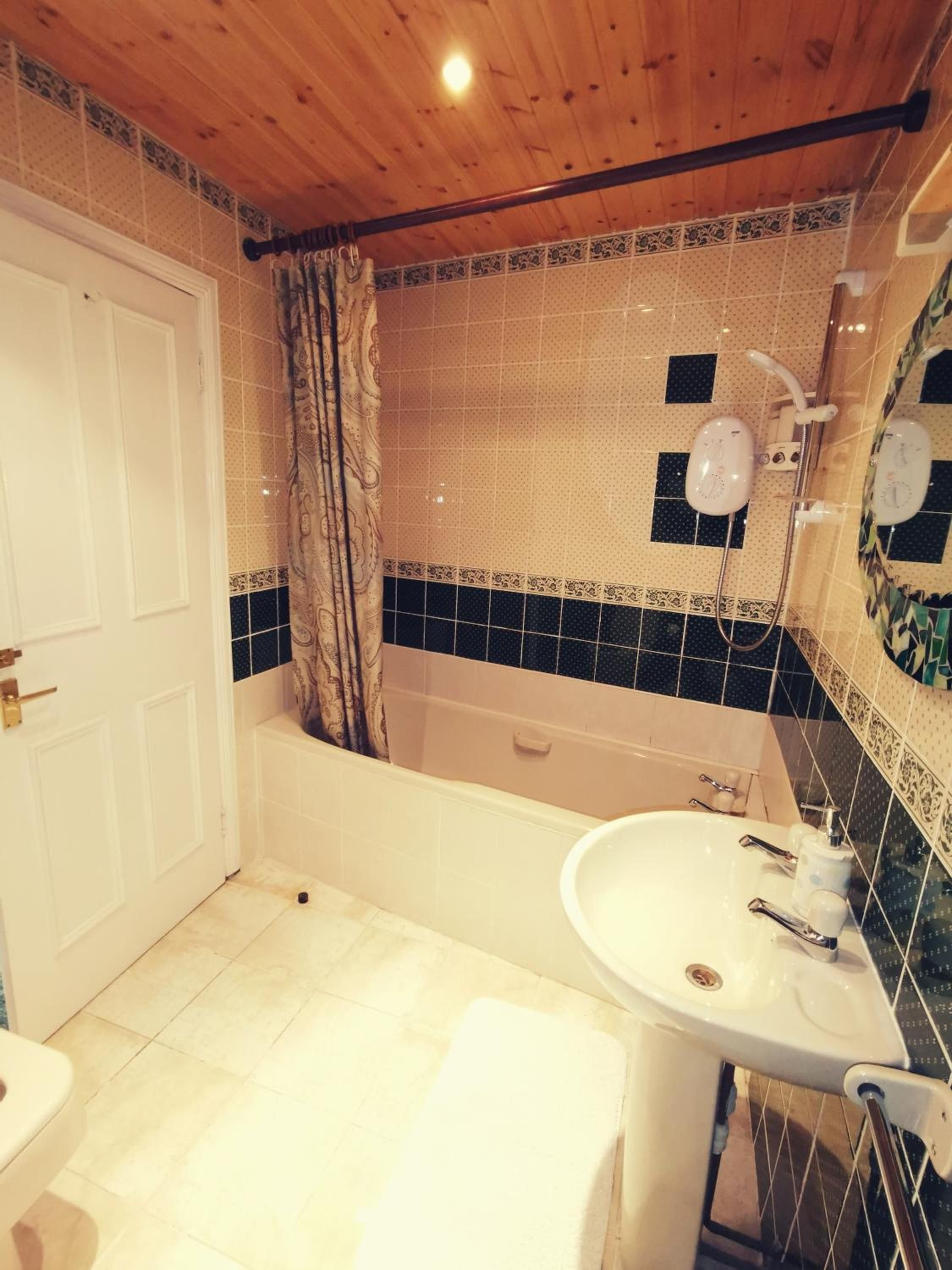 A bathroom with a bathtub, a sink, and a toilet.