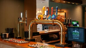 A bar area with a tap system and a computer monitor displaying a graph. - George Inn, Mere (Warminster)