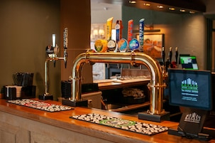 A bar area with a tap system and a computer monitor displaying a graph.