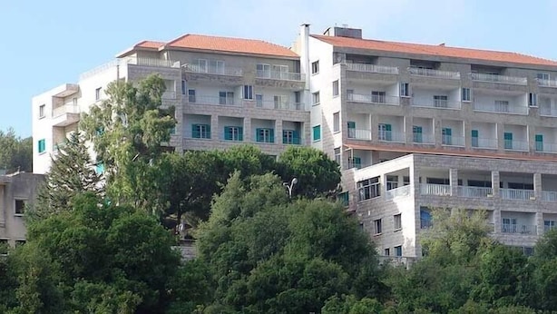 A multi-story building with balconies, surrounded by trees. - Hotel Monte bello (Ajaltoun)