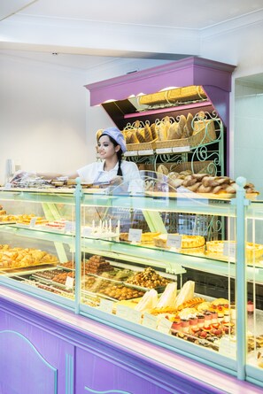 A bakery display case with various baked goods. - Greguar Hotel & Apartments (Kyiv)