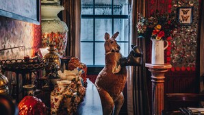 A room with a large window, a statue of a kangaroo, and various decorative items on a table. - The Zetter Clerkenwell (London)