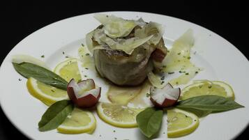 Un plat amb peix farcit, rodanxes de llimona i herbes.