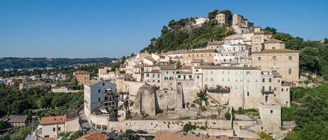 A historic town with a prominent castle-like structure surrounded by traditional buildings.