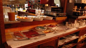 A buffet setup with various food items and utensils. - Hotel Rural Fonda de la Tea (Tejeda)