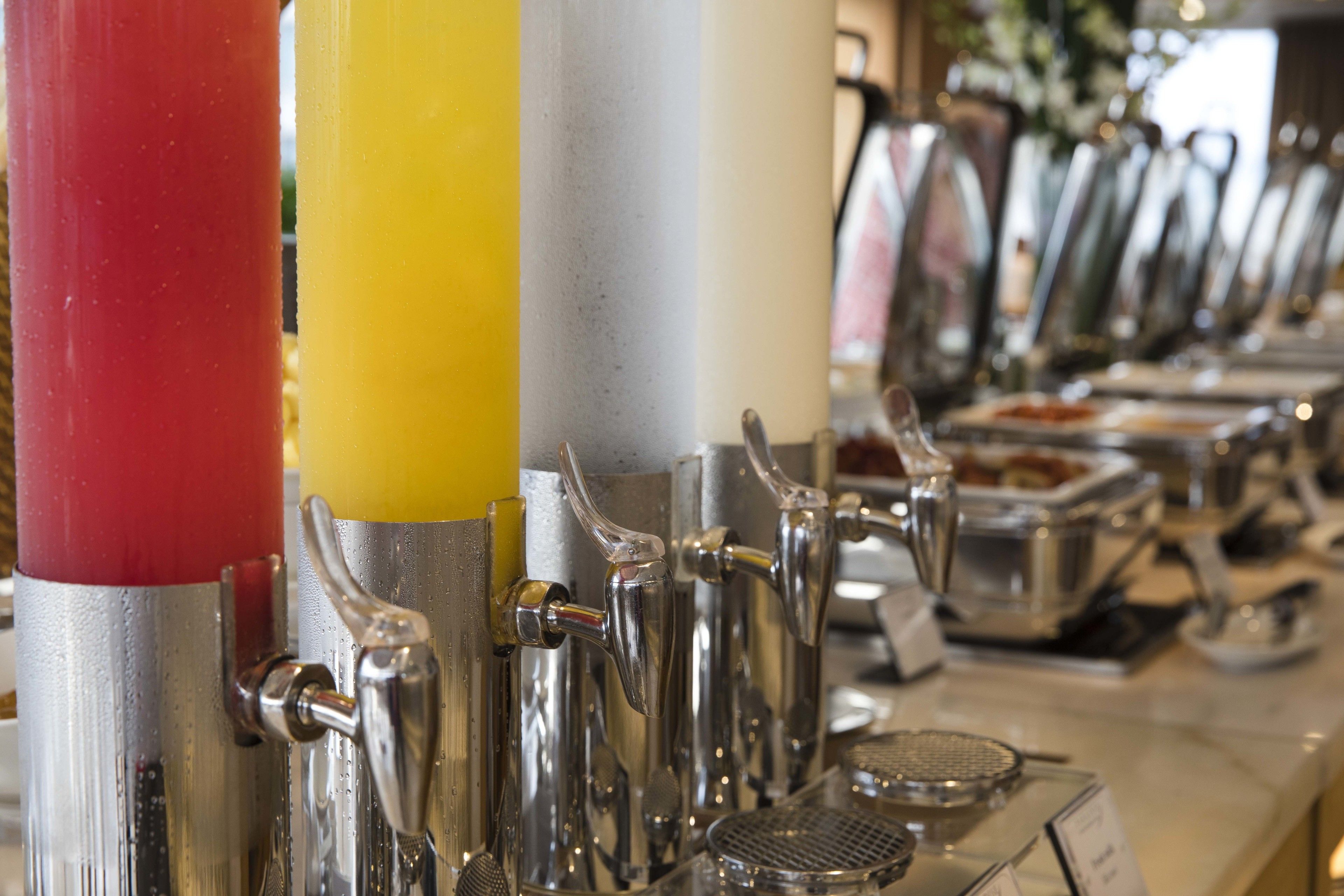 A beverage dispenser with multiple taps and a menu board.
