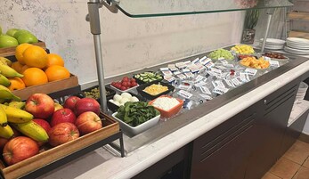 Buffet variado com frutas, legumes e produtos lácteos.