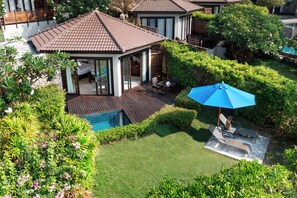 A residential property with a swimming pool, patio furniture, and a blue umbrella. - SAii Koh Samui Villas - Adults Only (Koh Samui)