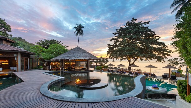 A resort pool area with a thatched-roof gazebo, lounge chairs, and a wooden deck. - SAii Koh Samui Villas - Adults Only (Koh Samui)