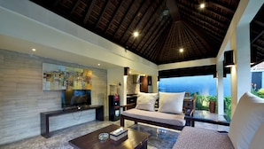 A modern living room with a TV, sofa, and coffee table. - The Khayangan Dreams Villa Umalas (Kerobokan)