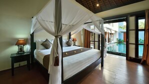 A four-poster bed with a canopy, a nightstand with a lamp, and a view of an infinity pool through large windows. - The Khayangan Dreams Villa Umalas (Kerobokan)