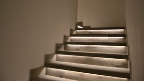A wooden staircase with built-in lighting.