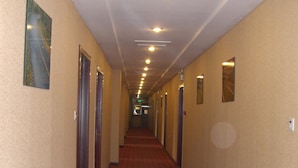 A hotel corridor with a red carpet, beige walls, and doors on both sides. - Super 8 Hotel- Jinan Coach Station Branch (Jinan)