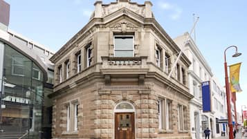 A historic building with a stone facade, a prominent entrance, and a sign reading "Cascade Brewery Office."