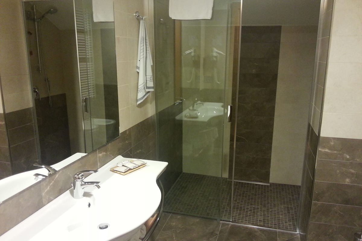 rainfall showerhead, hair dryer, bathrobes, slippers