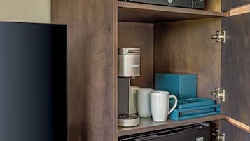 A kitchenette with a GE coffee maker, a Keurig, and a microwave.