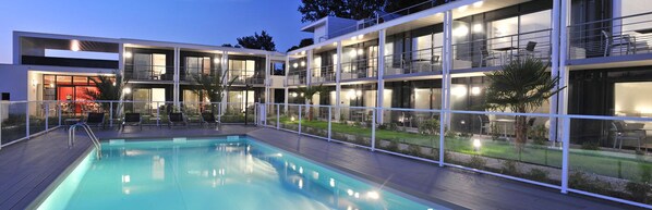 Outdoor pool, open 6:00 PM to 9:00 PM, pool umbrellas, pool loungers