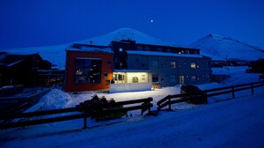 A hotel with a snow-covered mountain in the background.