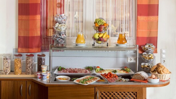 A buffet setup with various food items and beverages.