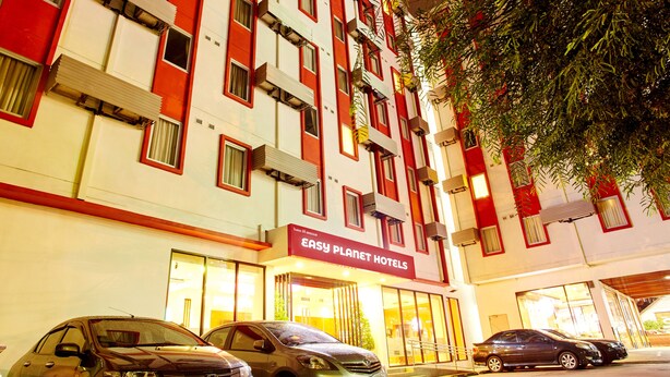 A multi-story building with a sign reading "Easy Planet Hotels".