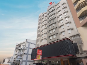 A multi-story building with a prominent Red Planet sign, indicating a hotel or similar establishment.
