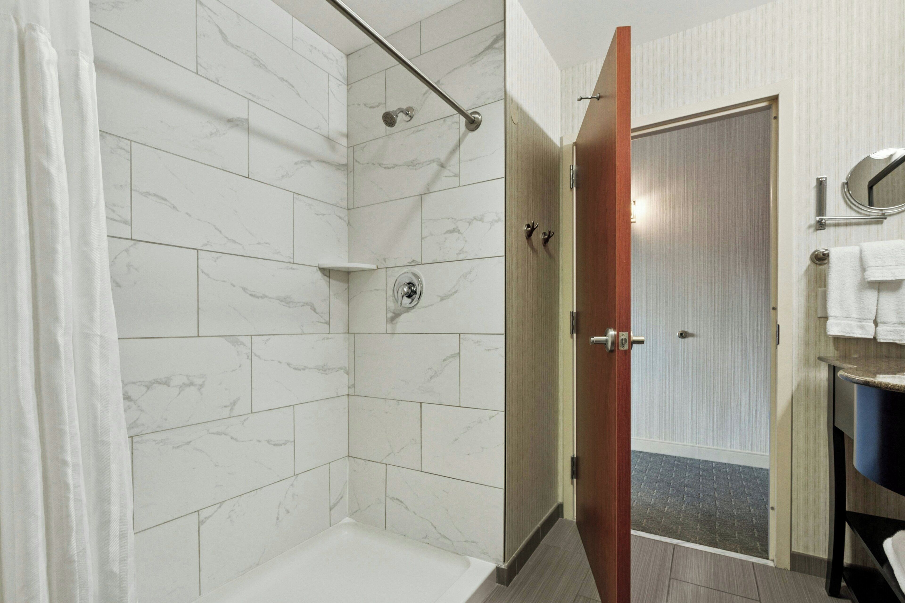 A bathroom with a shower, a toilet, and a sink.