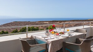 A table set for dining with a view of the ocean and hills. - Club Hotel Marazul (Adeje)